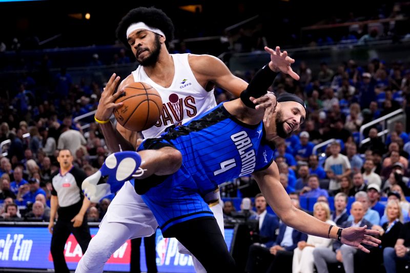 ORLANDO, FLORIDA - APRIL 25: Jarrett Allen #31 of the Cleveland Cavaliers and Jalen Suggs #4 of the Orlando Magic compete for a rebound during the first quarter of game three of the Eastern Conference First Round Playoffs at Kia Center on April 25, 2024 in Orlando, Florida. NOTE TO USER: User expressly acknowledges and agrees that, by downloading and or using this photograph, User is consenting to the terms and conditions of the Getty Images License Agreement. (Photo by Rich Storry/Getty Images)