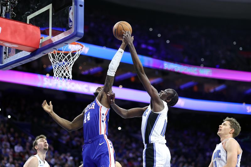 PHILADELPHIA, PENNSYLVANIA - FEBRUARY 01: Paul Reed #44 of the Philadelphia 76ers and Bol Bol #10 of the Orlando Magic challenge for the ball during the first half at Wells Fargo Center on February 01, 2023 in Philadelphia, Pennsylvania. NOTE TO USER: User expressly acknowledges and agrees that, by downloading and or using this photograph, User is consenting to the terms and conditions of the Getty Images License Agreement. (Photo by Tim Nwachukwu/Getty Images)