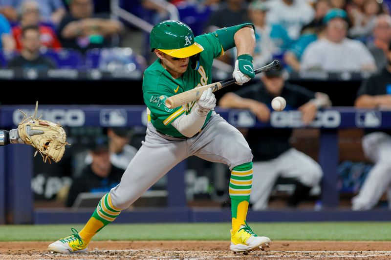 Jun 4, 2023; Miami, Florida, USA; Oakland Athletics shortstop Nick Allen (2) bunts for an RBI single against the Miami Marlins during the third inning at loanDepot Park. Mandatory Credit: Sam Navarro-USA TODAY Sports