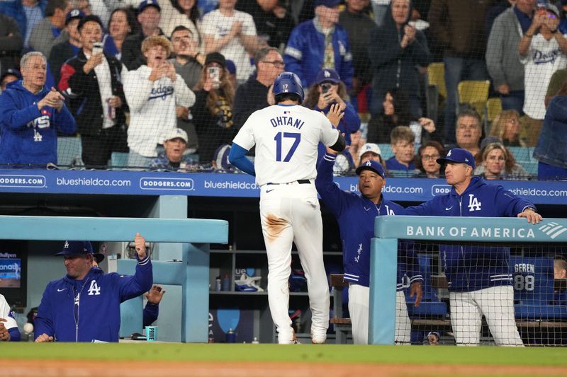 May 21, 2024; Los Angeles, California, USA; Los Angeles Dodgers designated hitter Shohei Ohtani (17) is congratulated by manager Dave Roberts after scoring in the sixth inning against the Arizona Diamondbacks at Dodger Stadium. Mandatory Credit: Kirby Lee-USA TODAY Sports