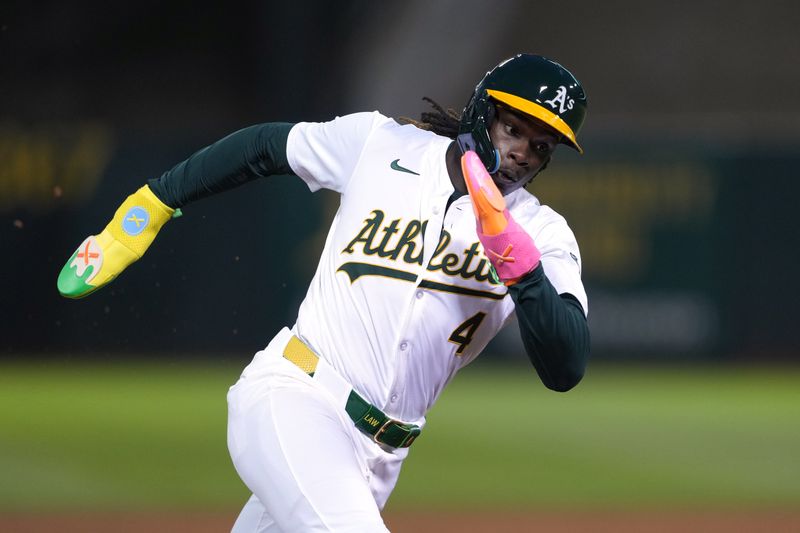 Aug 21, 2024; Oakland, California, USA; Oakland Athletics right fielder Lawrence Butler (4) rounds third base against the Tampa Bay Rays during the sixth inning at Oakland-Alameda County Coliseum. Mandatory Credit: Darren Yamashita-USA TODAY Sports