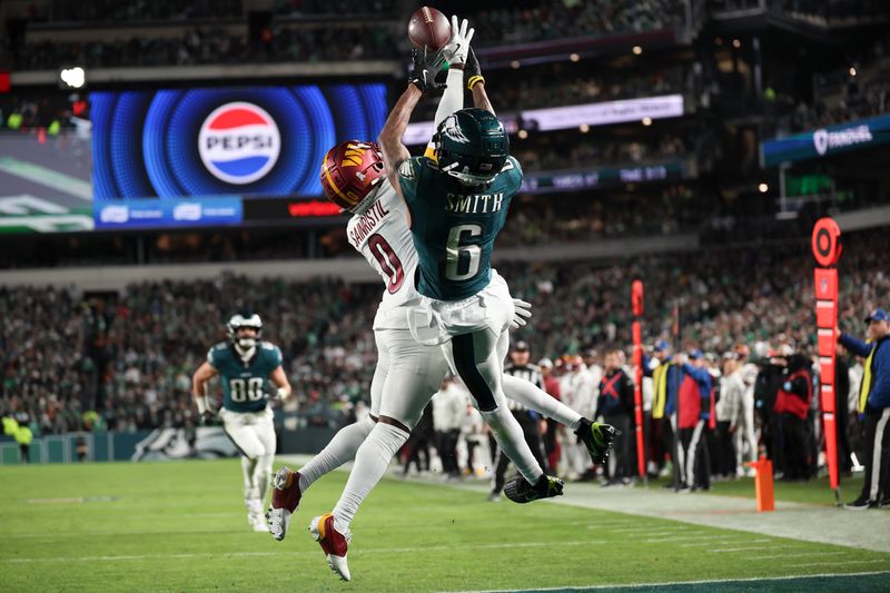 Washington Commanders cornerback Mike Sainristil (0) breaks up a pass intended for Philadelphia Eagles wide receiver DeVonta Smith (6) during an NFL football game, Thursday, Nov. 14, 2024, in Philadelphia, PA. (AP Photo/Peter Joneleit)