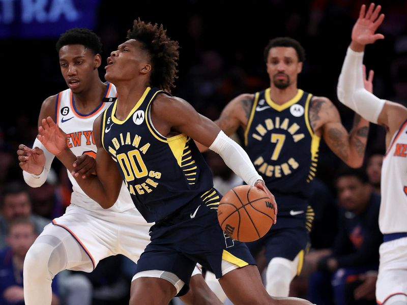 NEW YORK, NEW YORK - APRIL 09:  Bennedict Mathurin #00 of the Indiana Pacers drives around RJ Barrett #9 of the New York Knicks at Madison Square Garden on April 09, 2023 in New York City. NOTE TO USER: User expressly acknowledges and agrees that, by downloading and or using this photograph, User is consenting to the terms and conditions of the Getty Images License Agreement. (Photo by Elsa/Getty Images)