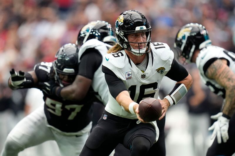 Jacksonville Jaguars quarterback Trevor Lawrence (16) looks to hand the ball off during the second half of an NFL football game against the Houston Texans, Sunday, Sept. 29, 2024, in Houston. (AP Photo/Eric Gay)