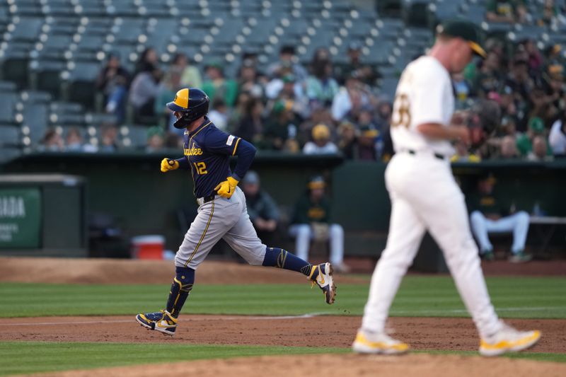 Aug 23, 2024; Oakland, California, USA; Milwaukee Brewers first baseman Rhys Hoskins (12) rounds the bases after hitting a home run after hitting a home run against Oakland Athletics starting pitcher JP Sears (right) during the second inning at Oakland-Alameda County Coliseum. Mandatory Credit: Darren Yamashita-USA TODAY Sports