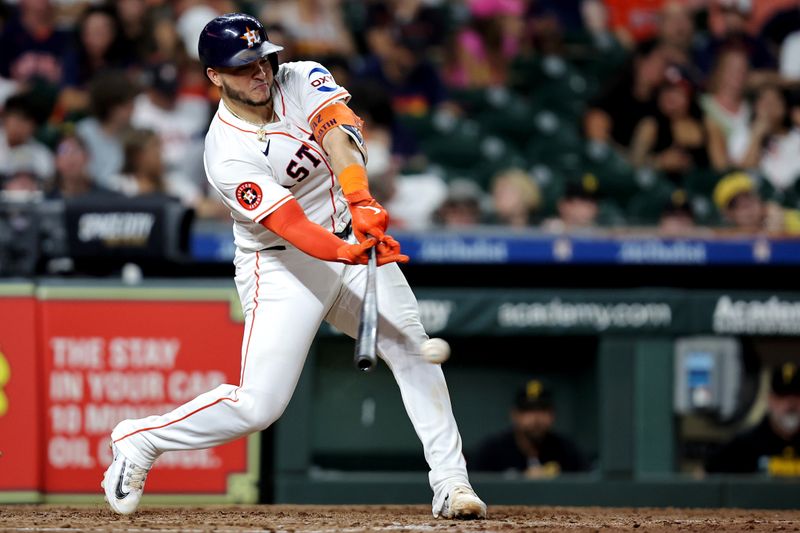 Jul 31, 2024; Houston, Texas, USA; Houston Astros catcher Yainer Diaz (21) hits a single against the Pittsburgh Pirates during the sixth inning at Minute Maid Park. Mandatory Credit: Erik Williams-USA TODAY Sports