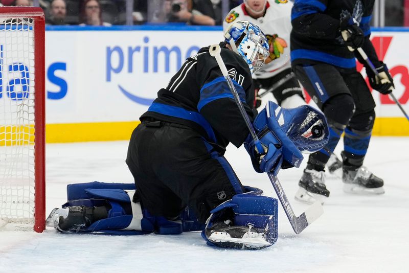 Dec 2, 2024; Toronto, Ontario, CAN; Toronto Maple Leafs goaltender Anthony Stolarz (41) makes a glove save against the Chicago Blackhawks during the second period at Scotiabank Arena. Mandatory Credit: John E. Sokolowski-Imagn Images