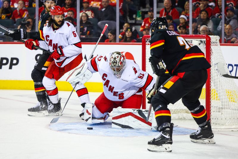 Oct 24, 2024; Calgary, Alberta, CAN; Carolina Hurricanes goaltender Pyotr Kochetkov (52) makes a save against the Calgary Flames during the third period at Scotiabank Saddledome. Mandatory Credit: Sergei Belski-Imagn Images