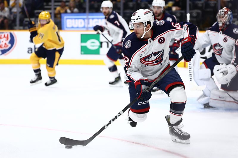 Oct 26, 2024; Nashville, Tennessee, USA; Columbus Blue Jackets right wing Kevin Labanc (62) takes the puck down ice in the first period against the Nashville Predators at Bridgestone Arena. Mandatory Credit: Casey Gower-Imagn Images