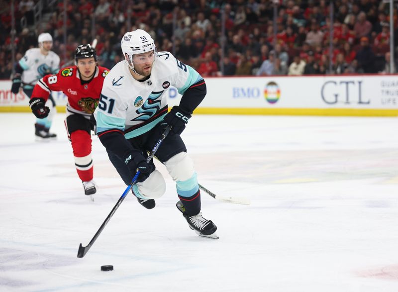 Mar 18, 2025; Chicago, Illinois, USA; Seattle Kraken center Shane Wright (51) skates with the puck during the first period against the Chicago Blackhawks at United Center. Mandatory Credit: Talia Sprague-Imagn Images