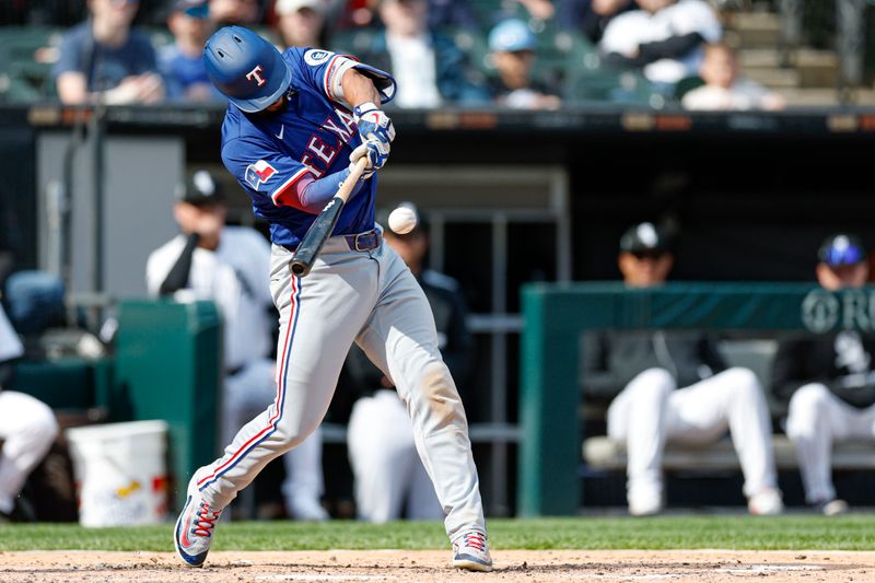 May 24, 2025; Chicago, Illinois, USA; Texas Rangers second baseman Marcus Semien (2) hits an RBI-sacrifice fly against the Chicago White Sox during the fourth inning at Rate Field. Mandatory Credit: Kamil Krzaczynski-Imagn Images