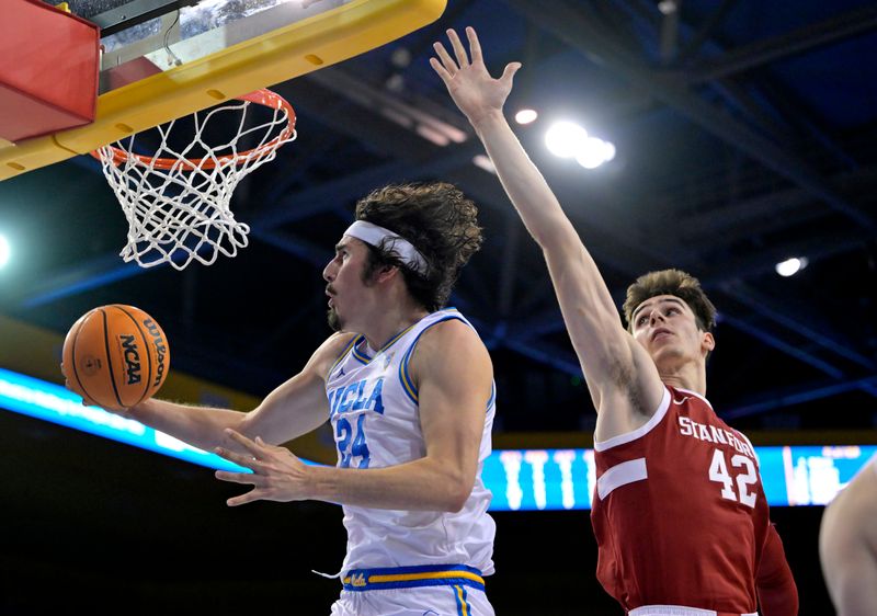 Feb 16, 2023; Los Angeles, California, USA; UCLA Bruins guard Jaime Jaquez Jr. (24) drives past Stanford Cardinal forward Maxime Raynaud (42) in the second half at Pauley Pavilion presented by Wescom. Mandatory Credit: Jayne Kamin-Oncea-USA TODAY Sports