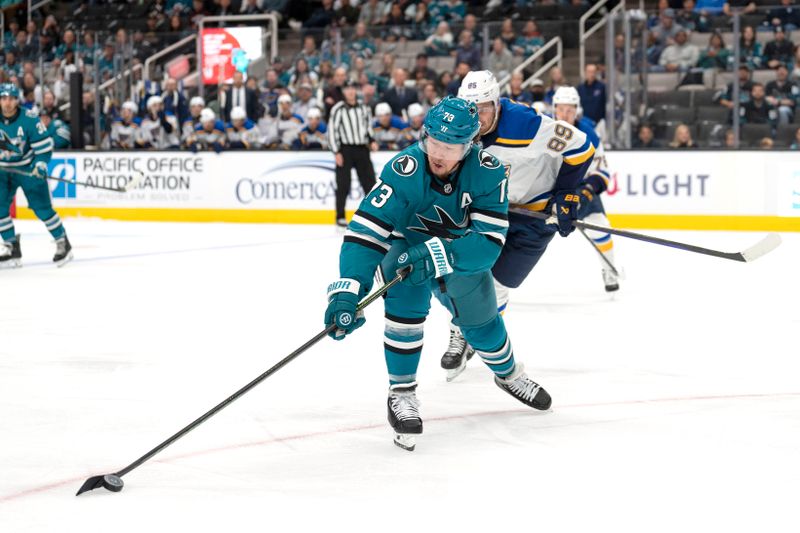 Oct 10, 2024; San Jose, California, USA; San Jose Sharks center Tyler Toffoli (73) reaches for the puck during the first period against St. Louis Blues left wing Pavel Buchnevich (89) at SAP Center at San Jose. Mandatory Credit: Stan Szeto-Imagn Images