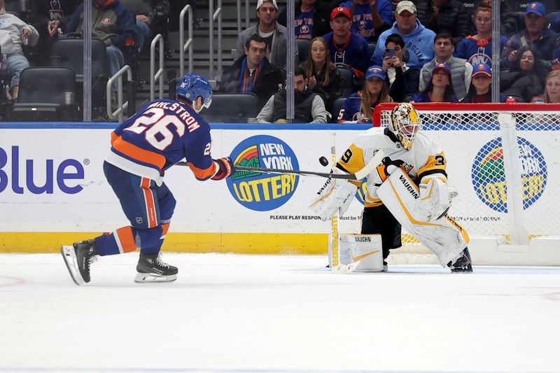 Nov 5, 2024; Elmont, New York, USA; Pittsburgh Penguins goaltender Alex Nedeljkovic (39) makes a save against New York Islanders right wing Oliver Wahlstrom (26) during the shootout at UBS Arena. Mandatory Credit: Brad Penner-Imagn Images