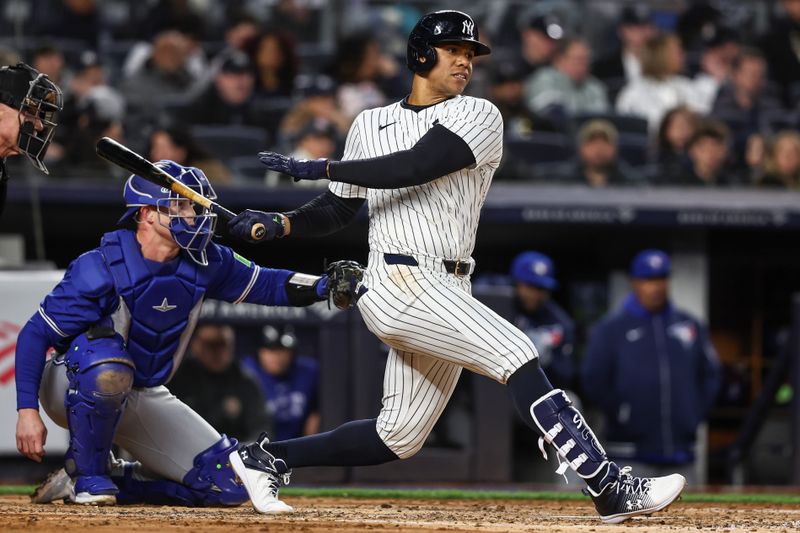 Apr 6, 2024; Bronx, New York, USA; New York Yankees right fielder Juan Soto (22) hits an RBI single in the second inning against the Toronto Blue Jays at Yankee Stadium. Mandatory Credit: Wendell Cruz-USA TODAY Sports