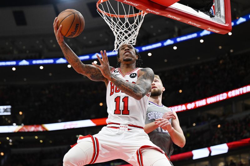 CHICAGO, ILLINOIS - MARCH 15: DeMar DeRozan #11 of the Chicago Bulls shoots in the first half against Domantas Sabonis #10 of the Sacramento Kings at United Center on March 15, 2023 in Chicago, Illinois.   NOTE TO USER: User expressly acknowledges and agrees that, by downloading and or using this photograph, User is consenting to the terms and conditions of the Getty Images License Agreement.  (Photo by Quinn Harris/Getty Images)