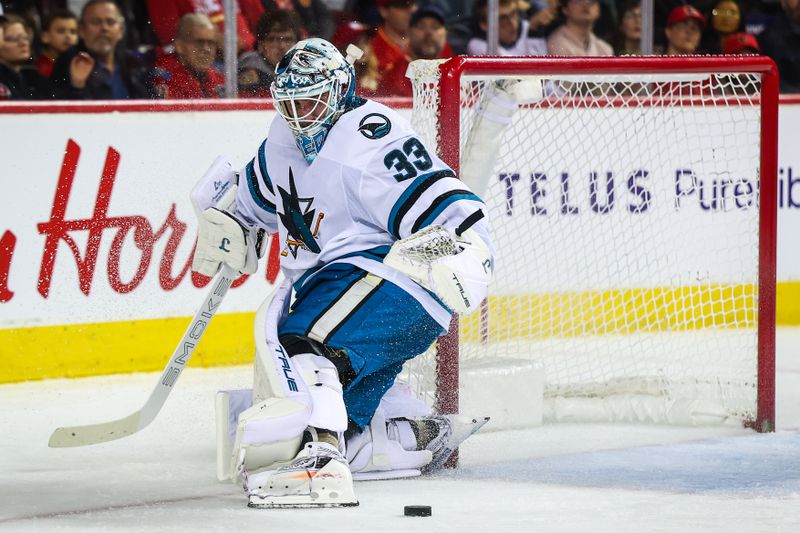 Jan 31, 2026; Calgary, Alberta, CAN; San Jose Sharks goaltender Alex Nedeljkovic (33) makes a save against the Calgary Flames during the second period at Scotiabank Saddledome. Mandatory Credit: Sergei Belski-Imagn Images