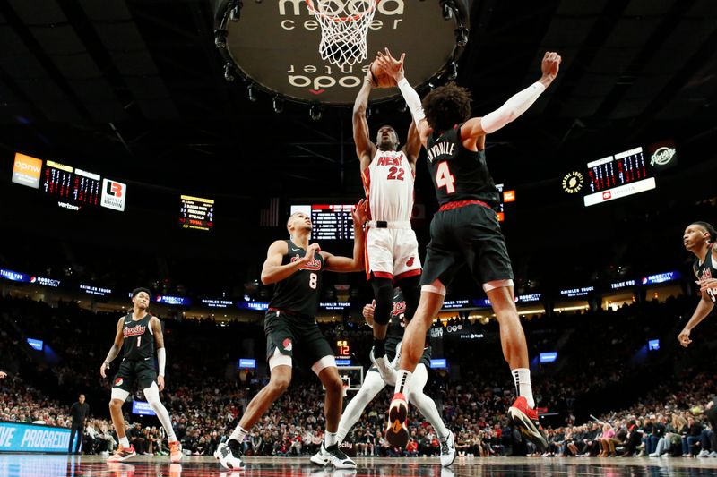 PORTLAND, OREGON - FEBRUARY 27: Jimmy Butler #22 of the Miami Heat dunks the ball over Matisse Thybulle #4 of the Portland Trail Blazers during the second half at Moda Center on February 27, 2024 in Portland, Oregon. NOTE TO USER: User expressly acknowledges and agrees that, by downloading and or using this photograph, User is consenting to the terms and conditions of the Getty Images License Agreement. (Photo by Soobum Im/Getty Images)