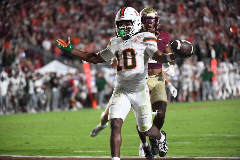 Oct 4, 2025; Tallahassee, Florida, USA; Miami Hurricanes wide receiver Malachi Toney (10) scores a touchdown during the second half against the Florida State Seminoles at Doak S. Campbell Stadium. Mandatory Credit: Robert Myers-Imagn Images