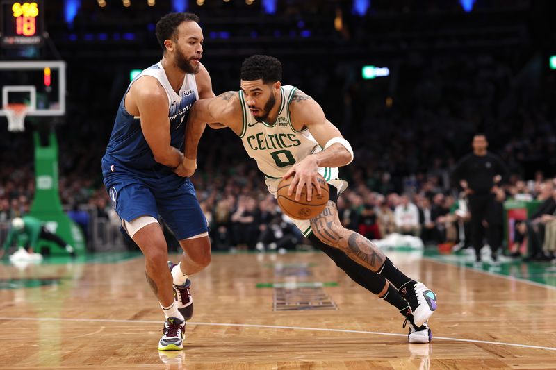 BOSTON, MASSACHUSETTS - JANUARY 10: Kyle Anderson #1 of the Minnesota Timberwolves defends Jayson Tatum #0 of the Boston Celtics  at TD Garden on January 10, 2024 in Boston, Massachusetts. The Celtics defeat the Timberwolves 127-120 in overtime. NOTE TO USER: User expressly acknowledges and agrees that, by downloading and or using this photograph, user is consenting to the terms and conditions of the Getty Images License Agreement.  (Photo by Maddie Meyer/Getty Images)