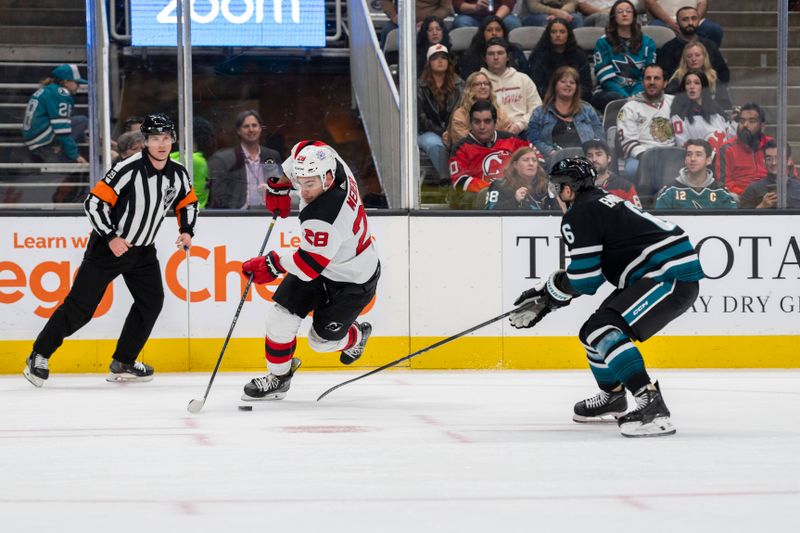 Feb 27, 2024; San Jose, California, USA;  New Jersey Devils right wing Timo Meier (28) controls the puck against San Jose Sharks defenseman Ty Emberson (6) during the first period at SAP Center at San Jose. Mandatory Credit: Neville E. Guard-USA TODAY Sports