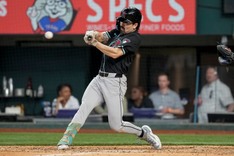 May 29, 2024; Arlington, Texas, USA;  Arizona Diamondbacks center fielder Corbin Carroll (7) connects for an RBI single against the Texas Rangers during the ninth inning at Globe Life Field. Mandatory Credit: Jim Cowsert-USA TODAY Sports