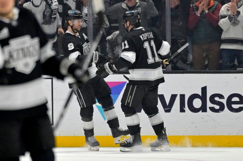 Nov 16, 2024; Los Angeles, California, USA; Los Angeles Kings right wing Adrian Kempe (9) celebrates an empty net goal on a pass from center Anze Kopitar (11) in the third period against the Detroit Red Wings at Crypto.com Arena. Mandatory Credit: Jayne Kamin-Oncea-Imagn Images