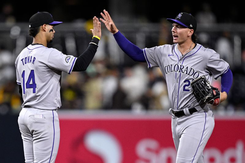 May 13, 2024; San Diego, California, USA; Colorado Rockies shortstop Ezequiel Tovar (14) and left fielder Jordan Beck (27) celebrate on the field after defeating the San Diego Padres at Petco Park. Mandatory Credit: Orlando Ramirez-USA TODAY Sports