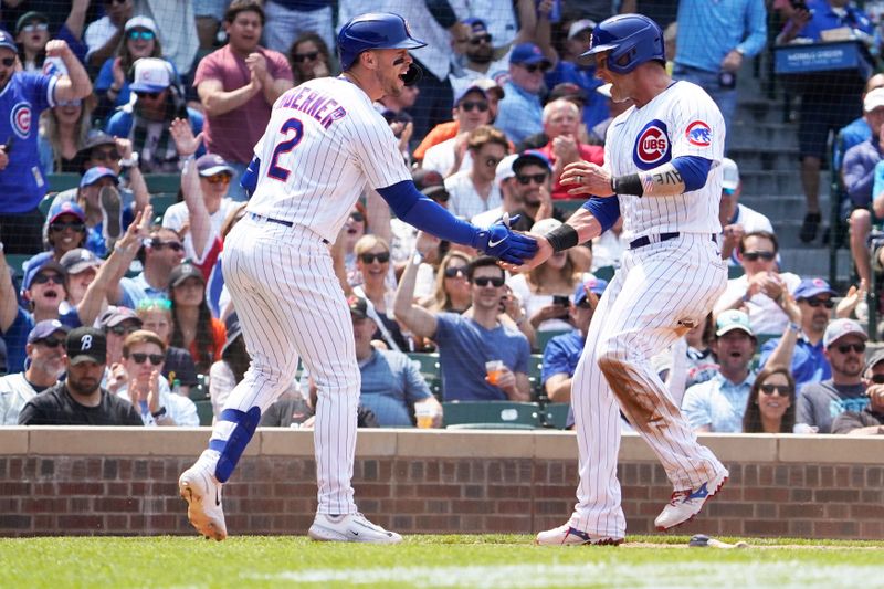 Jun 17, 2023; Chicago, Illinois, USA; Chicago Cubs catcher Yan Gomes (15) is greeted by Chicago Cubs second baseman Nico Hoerner (2) after scoring against the Baltimore Orioles during the fifth inning at Wrigley Field. Mandatory Credit: David Banks-USA TODAY Sports