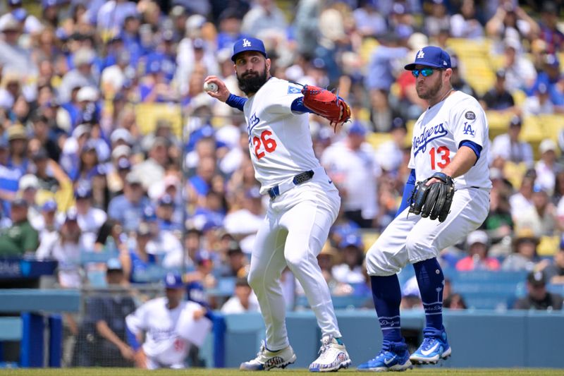 Apr 30, 2025; Los Angeles, California, USA; Los Angeles Dodgers starting pitcher Tony Gonsolin (26) throws out Miami Marlins shortstop Xavier Edwards (9) at first base after a bunt during the third inning at Dodger Stadium. Mandatory Credit: Jayne Kamin-Oncea-Imagn Images