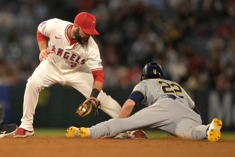 Jun 19, 2024; Anaheim, California, USA;  Milwaukee Brewers left fielder Christian Yelich (22) beats the tag by Los Angeles Angels second baseman Luis Guillorme (15) for a stolen base in the eighth inning at Angel Stadium. Mandatory Credit: Jayne Kamin-Oncea-USA TODAY Sports