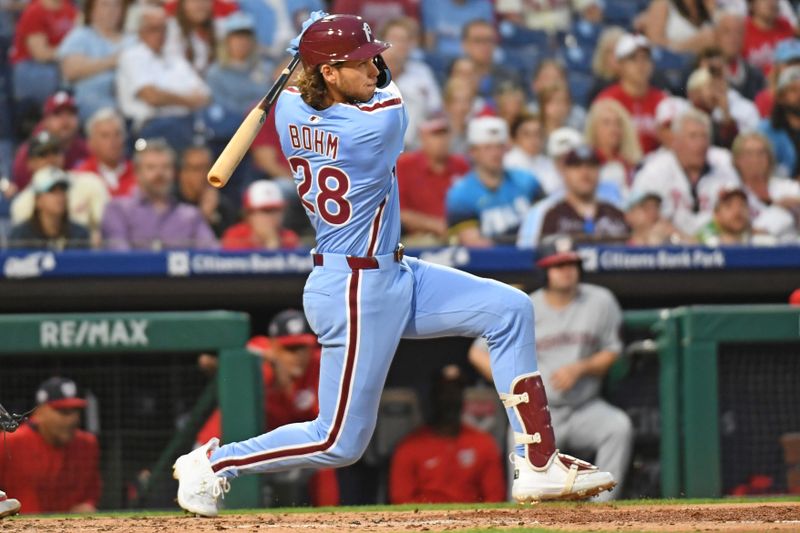 May 1, 2025; Philadelphia, Pennsylvania, USA;  Philadelphia Phillies third base Alec Bohm (28) hits an RBI single during the fifth inning against the Washington Nationals at Citizens Bank Park. Mandatory Credit: Eric Hartline-Imagn Images