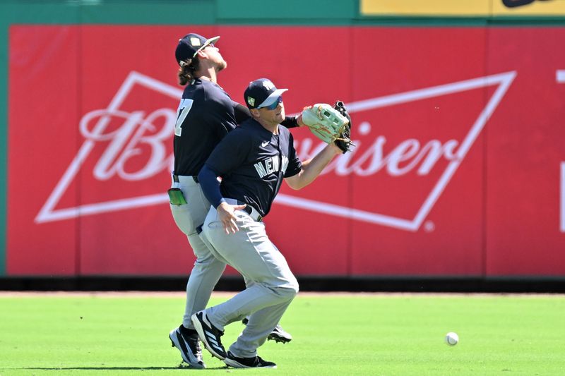 Mar 10, 2026; Clearwater, Florida, USA; New York Yankees second baseman Max Schuemann (30) and right fielder Kennedy Corona (87) collide while chasing a fly ball in the first inning against the Philadelphia Phillies during spring training at BayCare Ballpark. Mandatory Credit: Jonathan Dyer-Imagn Images