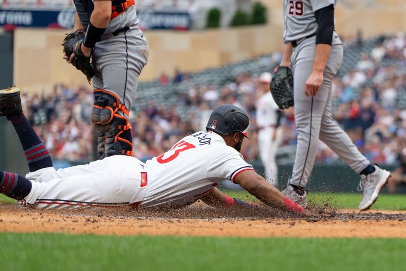 Jul 2, 2024; Minneapolis, Minnesota, USA; Minnesota Twins right fielder Manuel Margot (13) slides into home after scoring on a hit by Minnesota Twins third base Royce Lewis (23) against the Detroit Tigers at Target Field. Mandatory Credit: Matt Blewett-USA TODAY Sports