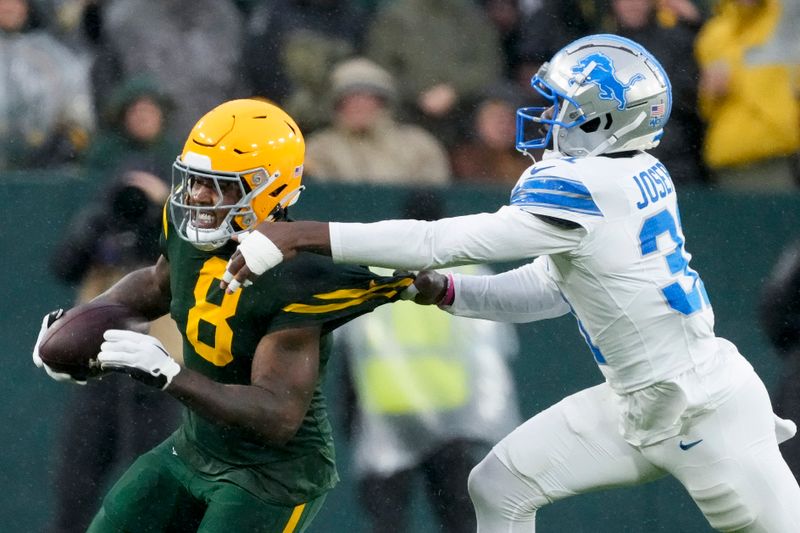 Green Bay Packers running back Josh Jacobs, left, is tackled by Detroit Lions safety Kerby Joseph (31) during the first half of an NFL football game Sunday, Nov. 3, 2024, in Green Bay, Wis. (AP Photo/Morry Gash)