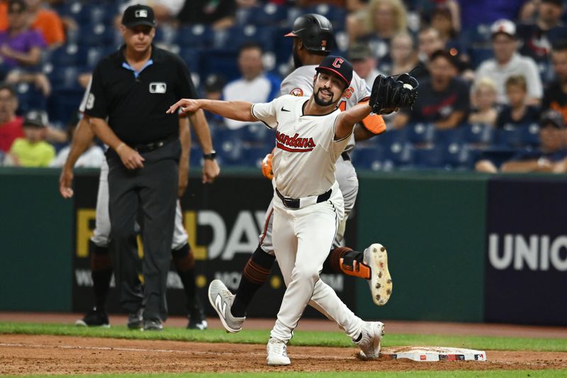 Aug 1, 2024; Cleveland, Ohio, USA; Cleveland Guardians relief pitcher Nick Sandlin (52) catches a throw from Cleveland Guardians shortstop Brayan Rocchio (not pictured) as Baltimore Orioles center fielder Cedric Mullins (31) is safe during the ninth inning at Progressive Field. Mandatory Credit: Ken Blaze-USA TODAY Sports