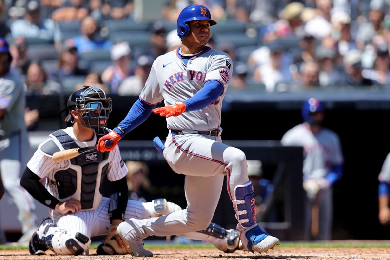 May 17, 2025; Bronx, New York, USA; New York Mets right fielder Juan Soto (22) follows through on a single against the New York Yankees during the fourth inning at Yankee Stadium. Mandatory Credit: Brad Penner-Imagn Images