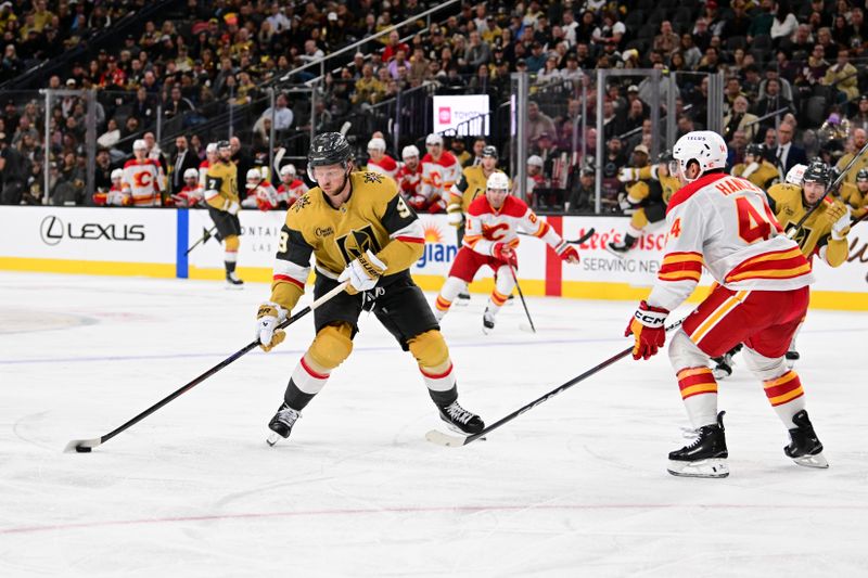 Oct 28, 2024; Las Vegas, Nevada, USA; Vegas Golden Knights center Jack Eichel (9) handles the puck against Calgary Flames defenseman Joel Hanley (44) in the second period at T-Mobile Arena. Mandatory Credit: Candice Ward-Imagn Images