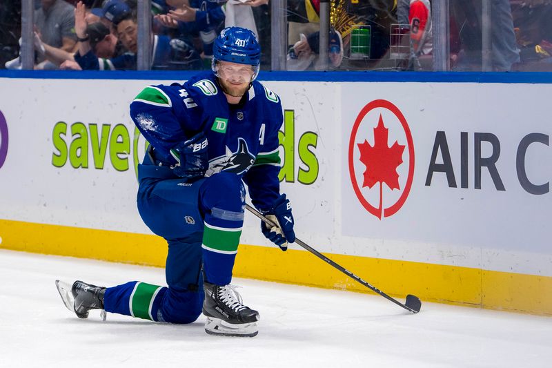 May 10, 2024; Vancouver, British Columbia, CAN; Vancouver Canucks forward Elias Pettersson (40) reacts after being checked by Edmonton Oilers defenseman Darnell Nurse (25) during the first period in game two of the second round of the 2024 Stanley Cup Playoffs at Rogers Arena. Mandatory Credit: Bob Frid-USA TODAY Sports