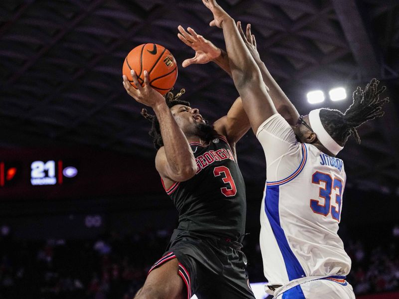 Feb 28, 2023; Athens, Georgia, USA; Georgia Bulldogs guard Kario Oquendo (3) tries to shoot over Florida Gators center Jason Jitoboh (33) during the second half at Stegeman Coliseum. Mandatory Credit: Dale Zanine-USA TODAY Sports