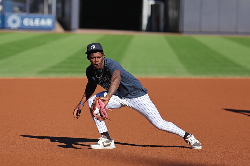 Oct 5, 2024; Bronx, New York, USA; New York Yankees third base Jazz Chisholm Jr. (13) warms up during batting practice before the game against Kansas City Royals during game one of the ALDS for the 2024 MLB Playoffs at Yankee Stadium. Mandatory Credit: Brad Penner-Imagn Images