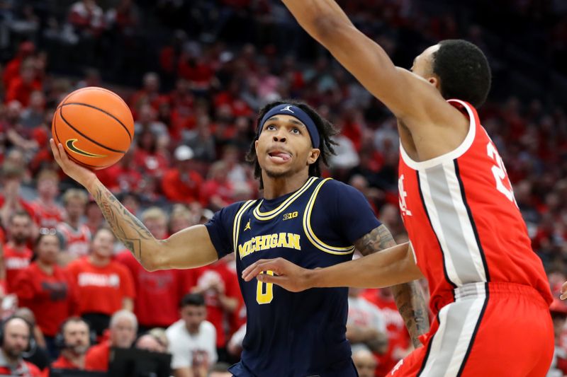 Mar 3, 2024; Columbus, Ohio, USA; Michigan Wolverines guard Dug McDaniel (0) takes the one hand shot as Ohio State Buckeyes forward Zed Key (23) defends during the first half at Value City Arena. Mandatory Credit: Joseph Maiorana-USA TODAY Sports