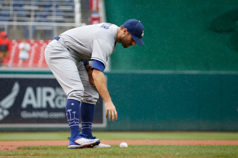 Sep 10, 2023; Washington, District of Columbia, USA; Los Angeles Dodgers third baseman Chris Taylor (3) picks up the ball after missing a fly in the fourth inning against the Washington Nationals at Nationals Park. Mandatory Credit: Amber Searls-USA TODAY Sports