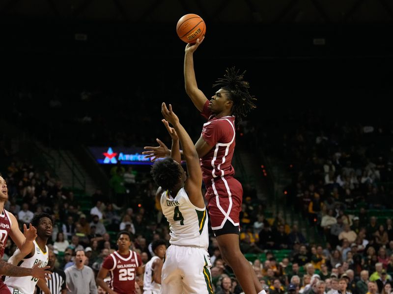 Feb 8, 2023; Waco, Texas, USA;  Oklahoma Sooners guard Otega Oweh (3) scores a basket over Baylor Bears guard LJ Cryer (4) during the first half at Ferrell Center. Mandatory Credit: Chris Jones-USA TODAY Sports