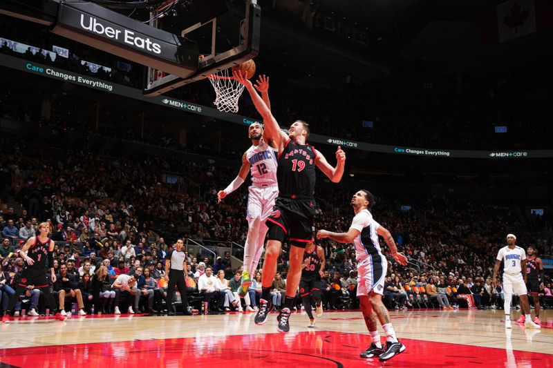 TORONTO, CANADA - JANUARY 3: Jakob Poeltl #19 of the Toronto Raptors drives to the basket during the game against the Orlando Magic on January 3, 2025 at the Scotiabank Arena in Toronto, Ontario, Canada.  NOTE TO USER: User expressly acknowledges and agrees that, by downloading and or using this Photograph, user is consenting to the terms and conditions of the Getty Images License Agreement.  Mandatory Copyright Notice: Copyright 2025 NBAE(Photo by Mark Blinch/NBAE via Getty Images)