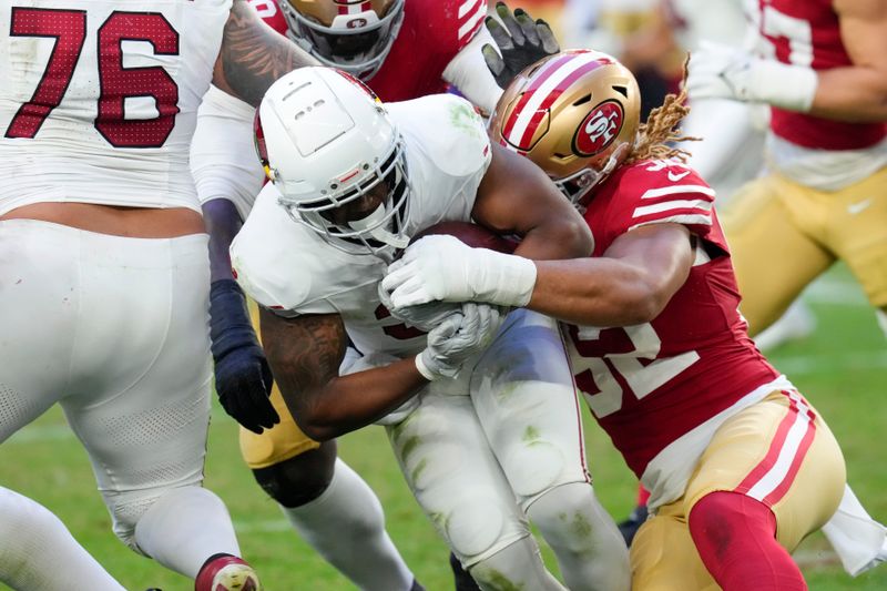 Arizona Cardinals running back Emari Demercado, center left, is tackled by San Francisco 49ers defensive end Chase Young during the second half of an NFL football game Sunday, Dec. 17, 2023, in Glendale, Ariz. (AP Photo/Ross D. Franklin)