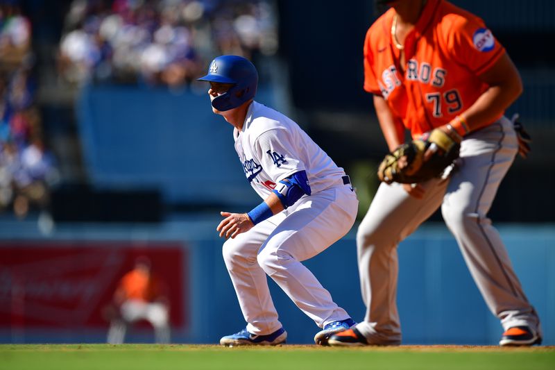 Jun 25, 2023; Los Angeles, California, USA; Los Angeles Dodgers catcher Will Smith (16) leads off from first ahead of Houston Astros first baseman Jose Abreu (79) during the fourth inning at Dodger Stadium. Mandatory Credit: Gary A. Vasquez-USA TODAY Sports