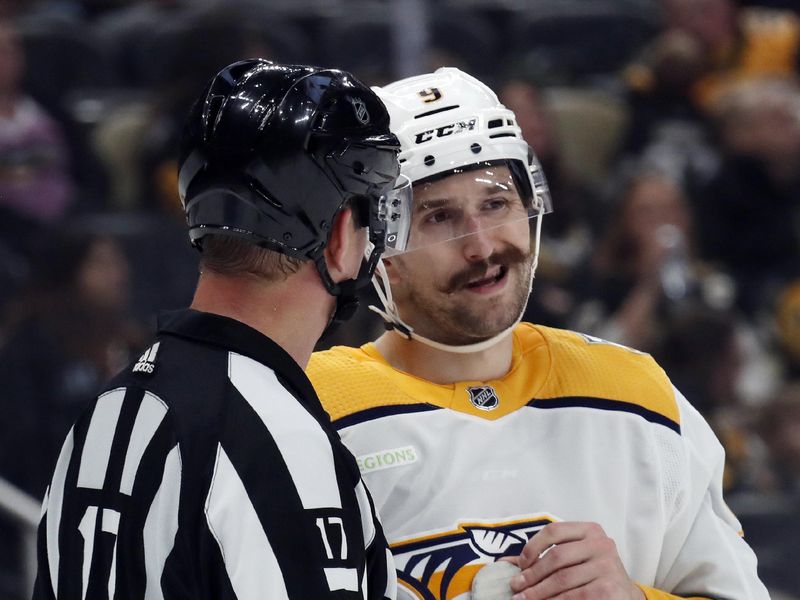 Apr 15, 2024; Pittsburgh, Pennsylvania, USA;  NHL referee Frederick L'Ecuyer (17) talks with Nashville Predators left wing Filip Forsberg (9) against the Pittsburgh Penguins during the second period at PPG Paints Arena. Mandatory Credit: Charles LeClaire-USA TODAY Sports