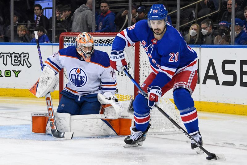 Dec 22, 2023; New York, New York, USA;  New York Rangers left wing Chris Kreider (20) plays the puck in front of Edmonton Oilers goaltender Stuart Skinner (74) during the second period at Madison Square Garden. Mandatory Credit: Dennis Schneidler-USA TODAY Sports