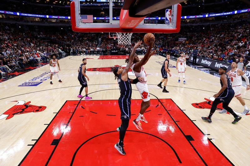 CHICAGO, IL - OCTOBER 30: Ayo Dosunmu #11 of the Chicago Bulls drives to the basket during the game against the Orlando Magic on October 30, 2024 at United Center in Chicago, Illinois. NOTE TO USER: User expressly acknowledges and agrees that, by downloading and or using this photograph, User is consenting to the terms and conditions of the Getty Images License Agreement. Mandatory Copyright Notice: Copyright 2024 NBAE (Photo by Kamil Krzaczynski/NBAE via Getty Images)